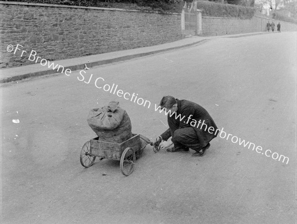 BOY WITH SACK IN HAND CART